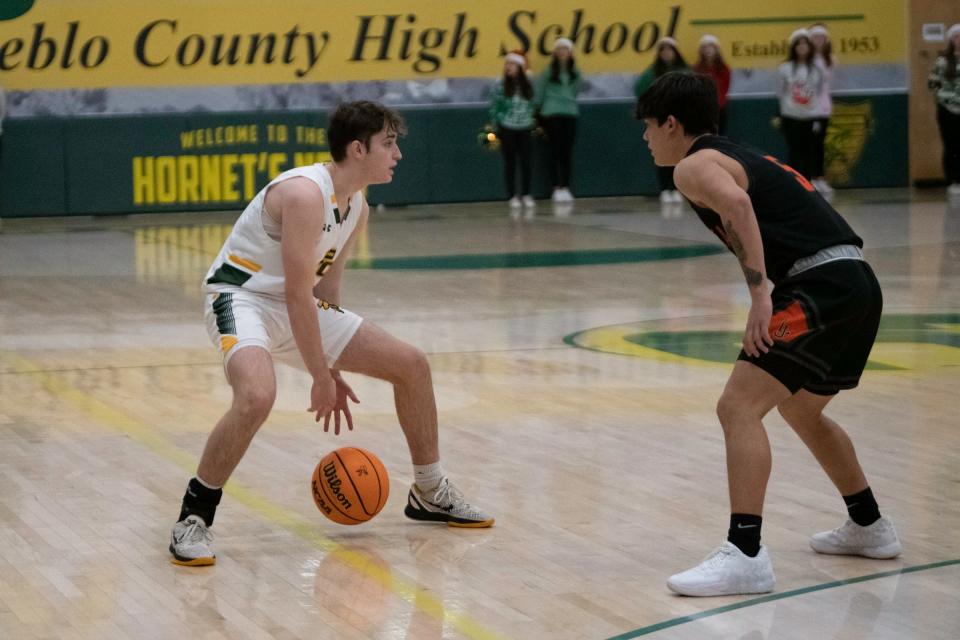 Pueblo County's Nico Valentine dribbles between his legs in front of a La Junta defender on Tuesday, Dec. 20, 2022.