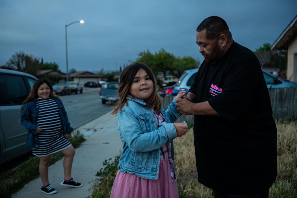 Fred Segura rolls up his daughter Paloma's sleeve early morning. He gets ready to drive over 85 miles to work and take his daughter to school at San Antonio Elementary School in Lockwood, Calif., on Thursday, March 31, 2022.