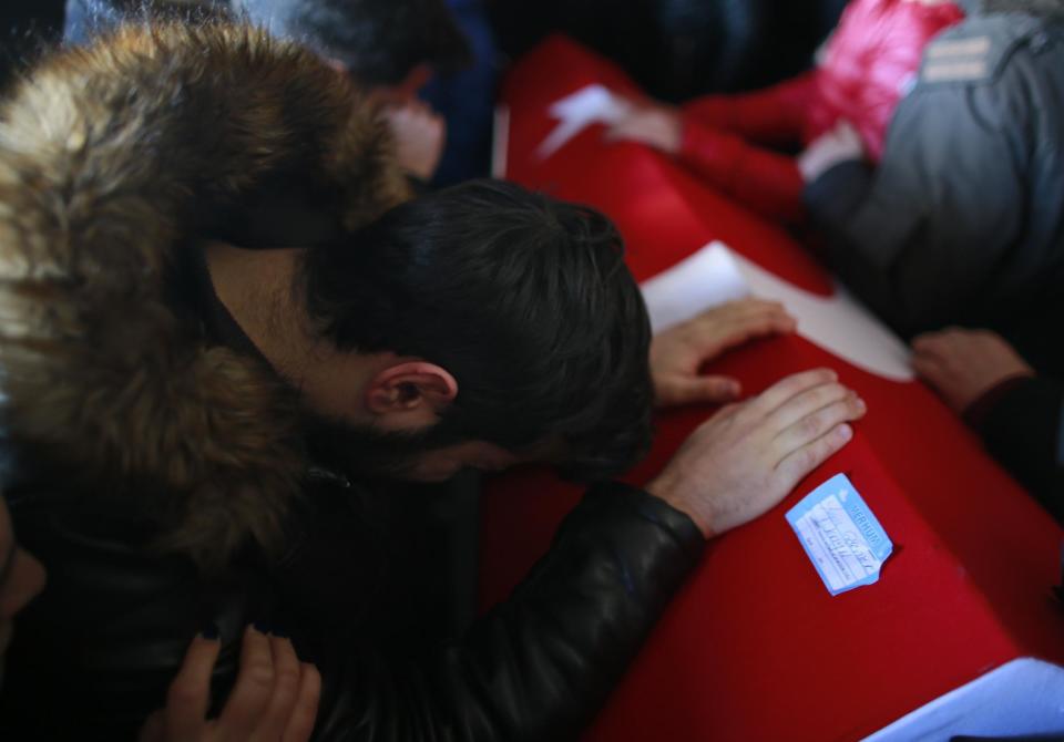 A mourner cries over the Turkish flag-draped coffin of Yunus Gormek, 23, one of the victims of the attack at a nightclub on New Year's Day, during the funeral in Istanbul, Monday, Jan. 2, 2017. An assailant armed with a long-barrelled weapon, opened fire at the nightclub in Istanbul's Ortakoy district during New Year's celebrations, killing dozens of people and wounding many others. (AP Photo/Emrah Gurel)