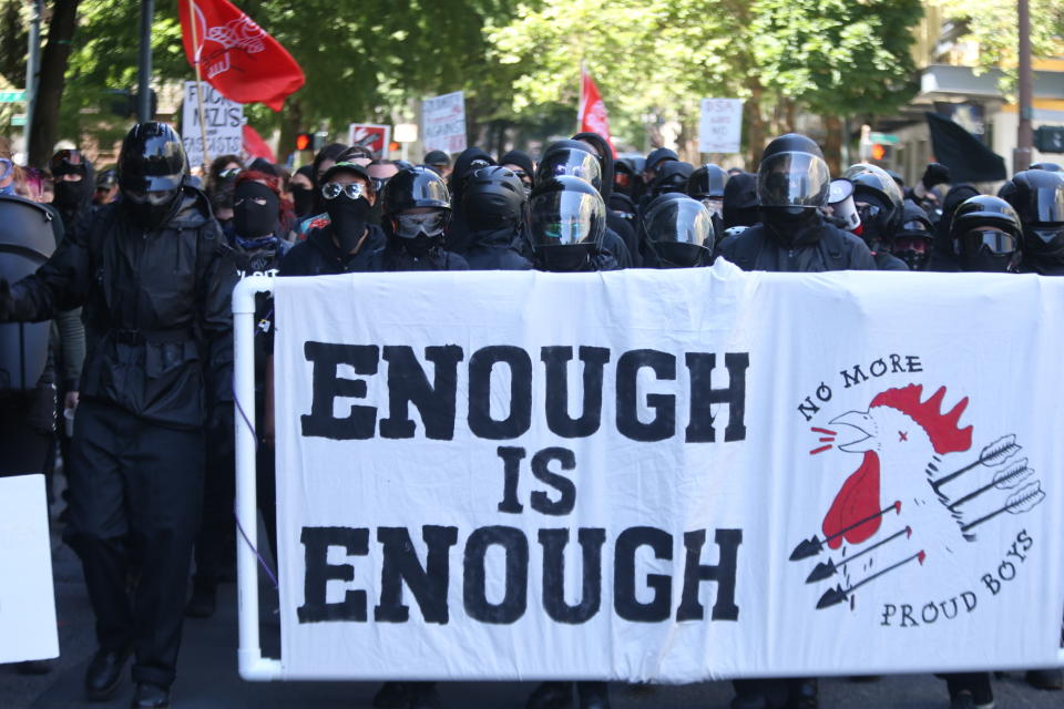 Multiple groups, including Rose City Antifa, the Proud Boys and conservative activist Haley Adams protest in downtown Portland, Ore., Saturday, June 29, 2019. (Dave Killen/The Oregonian via AP)