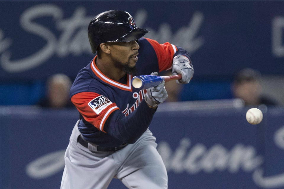 Minnesota Twins’ Byron Buxton bunts for a single off Toronto Blue Jays pitcher J.A. Happ (Chris Young/The Canadian Press via AP)