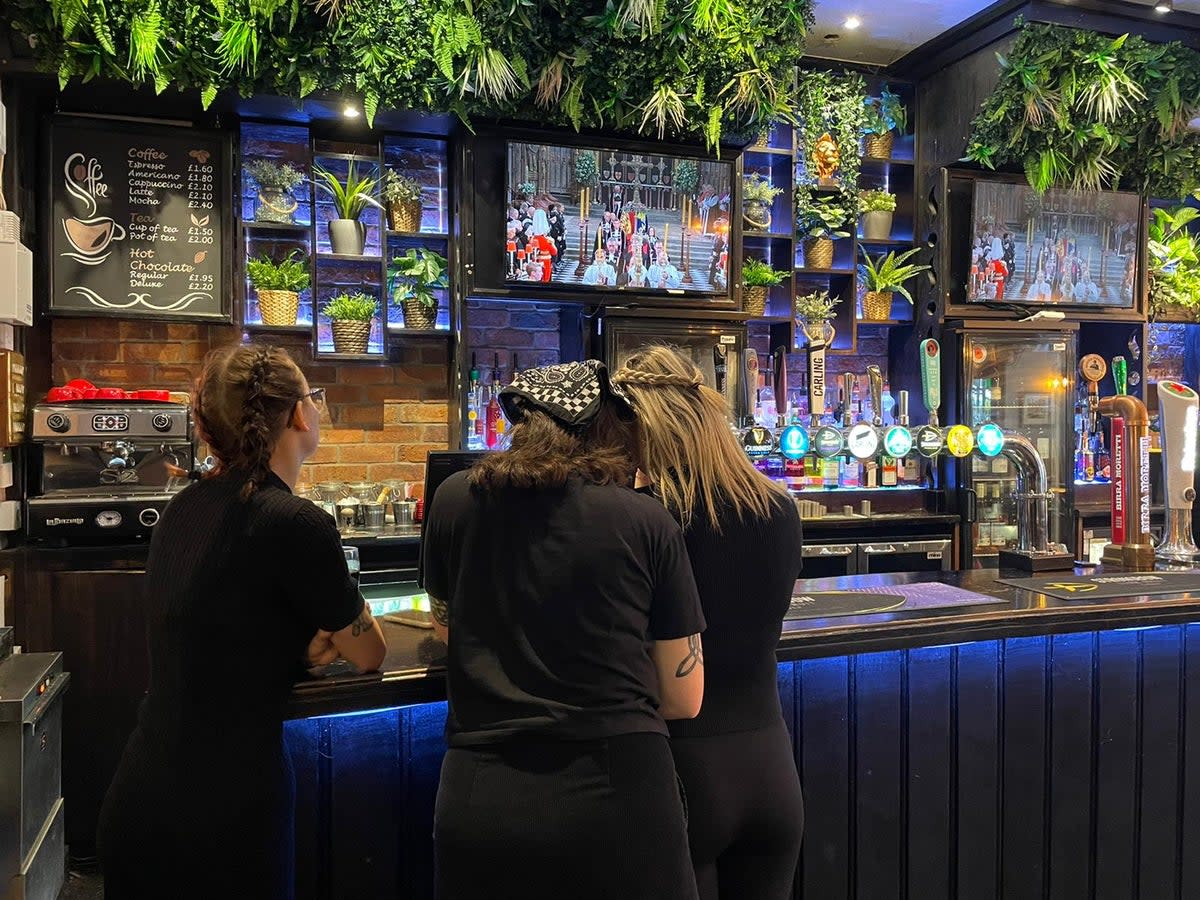 Tearful bartenders watch the Queen’s funeral in The Lion pub in Treorchy (PA)