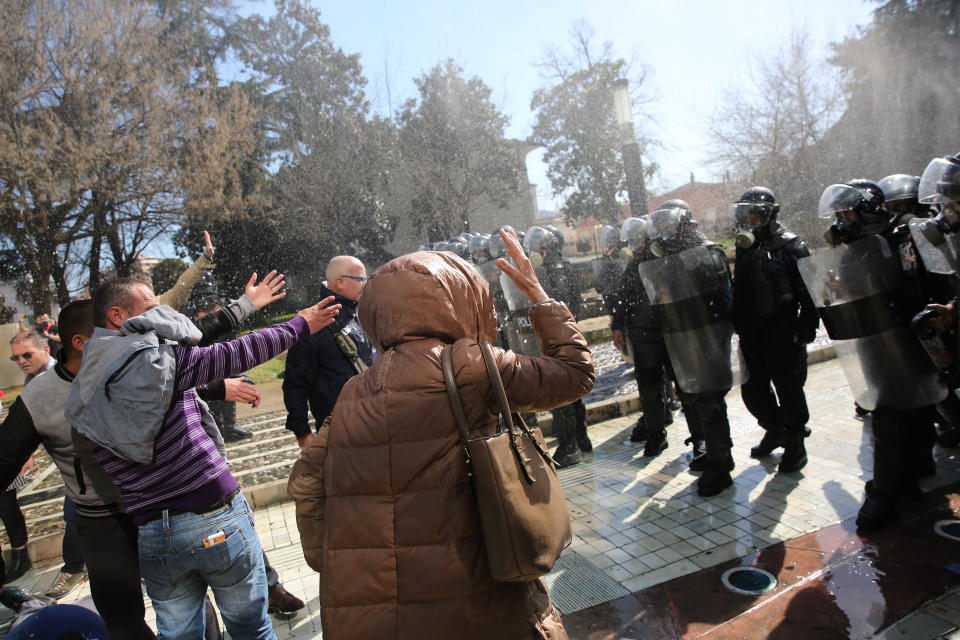 Protesters clash with police as thousands of opposition supporters protest in Tirana, Albania on Saturday, March 16, 2019. Albanian opposition supporters clashed with police while trying to storm the parliament building Saturday in a protest against the government which they accuse of being corrupt and linked to organized crime.(AP Photo/Visar Kryeziu)