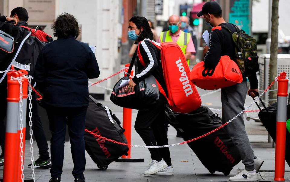 Tennis players, coaches and officials arrived at a hotel in Melbourne on Friday, before quarantining for two weeks ahead of the Australian Open - WILLIAM WEST/AFP