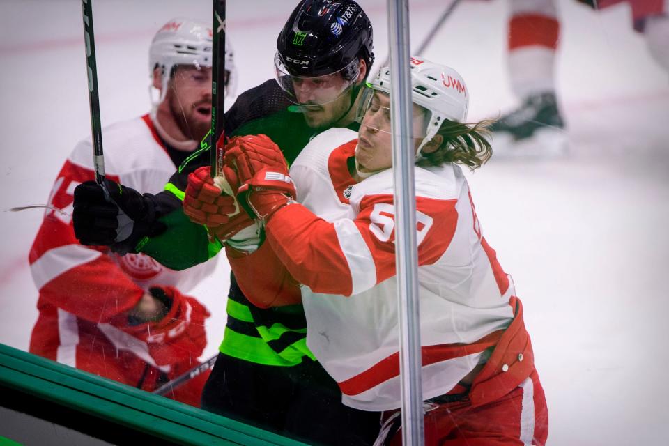 Detroit Red Wings left wing Tyler Bertuzzi (59) checks Dallas Stars right wing Nick Caamano (17) during the first period Jan. 28, 2021, at the American Airlines Center.