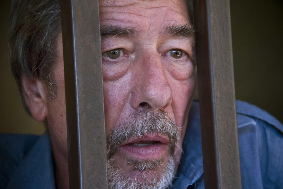 Briton Bernard Randall, 65, stands in a holding cell after a court hearing which ordered him to be deported, at the Chief Magistrates court in Entebbe, Uganda Wednesday, Jan. 22, 2014. A Ugandan court on Wednesday ordered the deportation of Randall who faced criminal charges following publication of images of him having sex with another man, in Uganda where homosexuality is illegal and lawmakers recently passed a draconian new bill that prescribes life imprisonment for "aggravated" homosexual acts. (AP Photo/Rebecca Vassie)