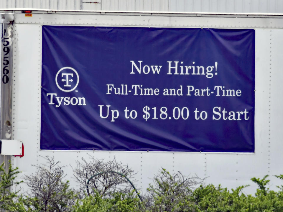 EMPORIA, KS - MAY 6: Now hiring signs in both English and Spanish are posted around the entrance to the Tyson fresh meats plant in Emporia, Kansas as businesses look to hire employees and increase normal production after the COVID-19 pandemic on May 6, 2021. Credit: Mark Reinstein/MediaPunch /IPX