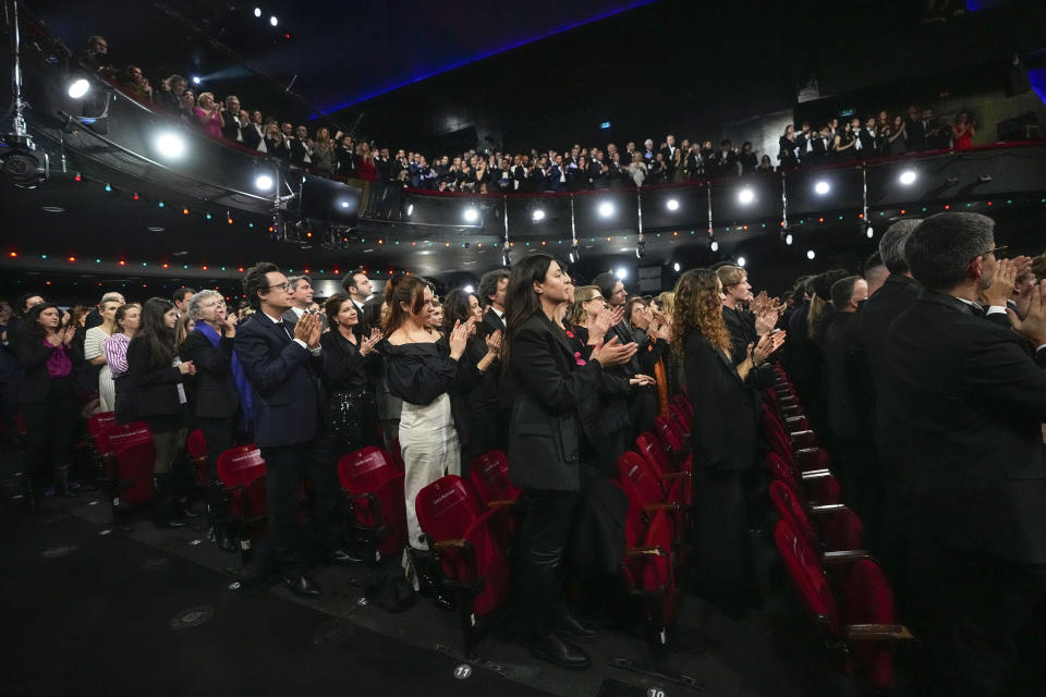 Standing ovation after the speech of French actress Judith Godreche during the 49th Cesar Award ceremony in Paris, Friday, Feb. 23, 2024. French actress Judith Godreche has called on France's film industry to "face the truth" on sexual violence and physical abuse during a live broadcast Friday of the Cesar Awards ceremony, France's version of the Oscars. (AP Photo/Michel Euler)