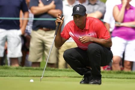 Tiger Woods checks out the green before putting on the 2nd hole in the final round of the Quicken Loans National golf tournament at Robert Trent Jones Golf Club. Mandatory Credit: Rafael Suanes-USA TODAY Sports