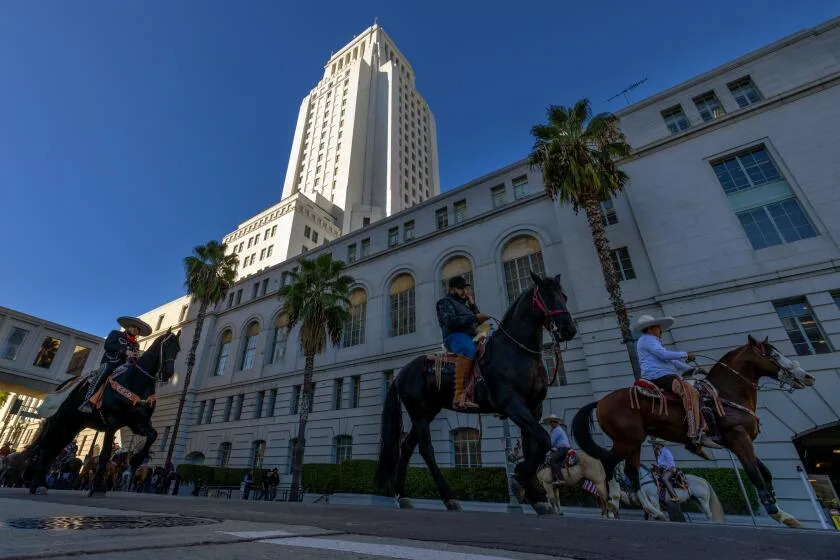 LOS ANGELES, CA - DECEMBER 05: Supporters of rodeo on their horses rally outside city hall as L.A. City Council debates banning rodeo in city limits on Tuesday, Dec. 5, 2023 in Los Angeles, CA. (Irfan Khan / Los Angeles Times)