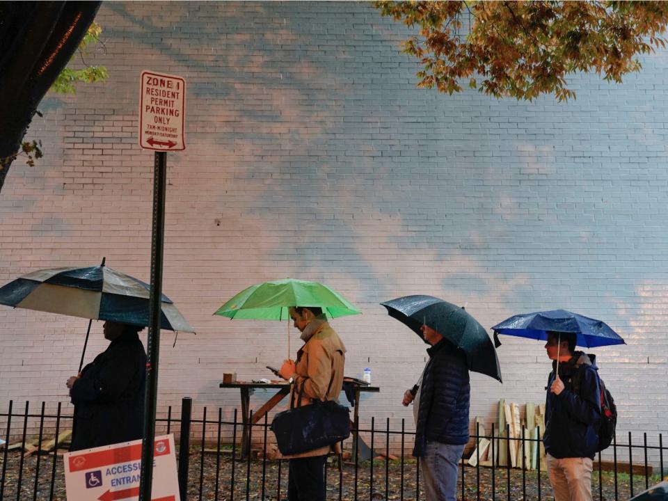 Voters line up in the rain outside Bright Family and Youth Center in the Columbia Heights neighborhood in Washington.