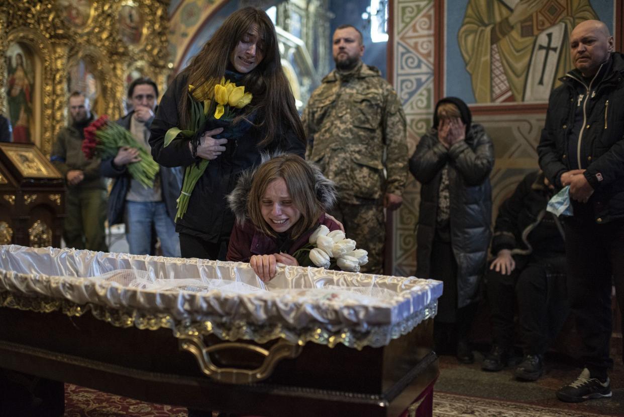 Relatives of journalist Maks Levin cry at his coffin during his funeral on April 4, 2022 in Kyiv, Ukraine. 