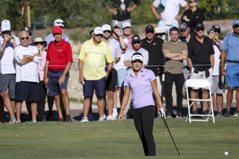 Crowds watch as Lexi Thompson, center front, watches her putt on the seventh hole during the first day of the Shriners Children's Open golf tournament, Thursday, Oct. 12, 2023, in Las Vegas. (AP Photo/Ian Maule)