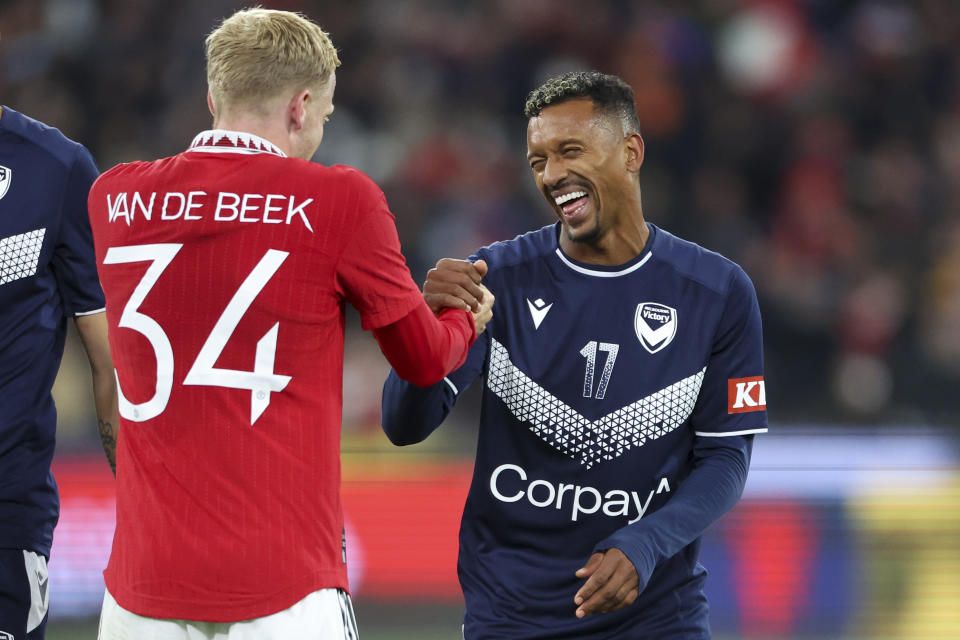 Melbourne Victory's Luis Nani, right, reacts with Manchester United's Donny ven de Beek during the soccer match between Manchester United and Melbourne Victory at the Melbourne Cricket Ground, Australia, Friday, July 15, 2022. (AP Photo/Asanka Brendon Ratnayake)