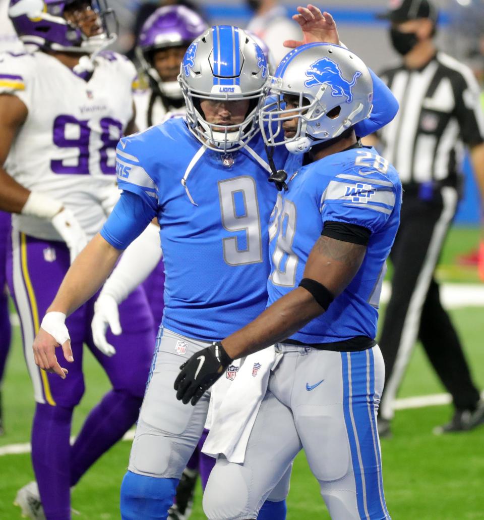 Lions quarterback Matthew Stafford and running back Adrian Peterson celebrate after a touchdown during the first half of the 37-35 loss to the Vikings at Ford Field on Sunday, January 3, 2021.