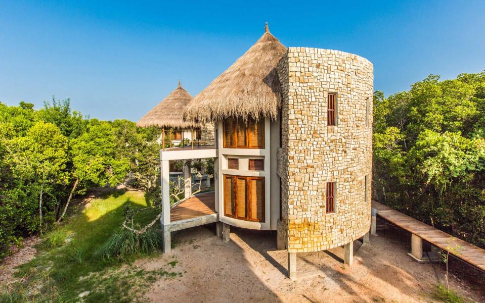 The exterior of a thatched cabana at Sen Wellness