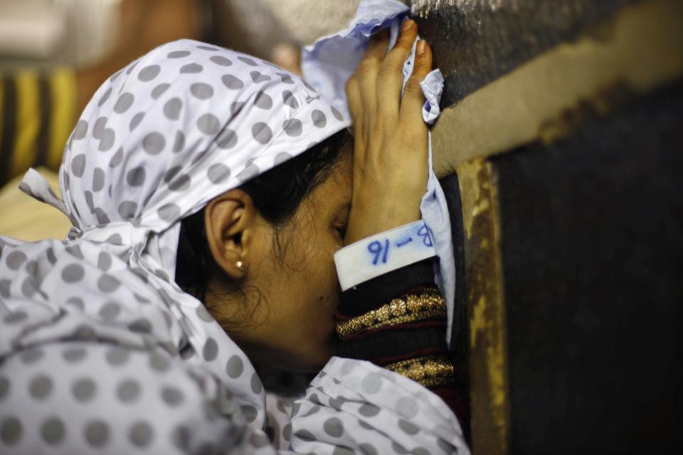 A Muslim pilgrim touches the Kaaba at the Grand Mosque in the holy city of Mecca ahead of the annual Haj pilgrimage October 7, 2013. REUTERS/Ibraheem Abu Mustafa (SAUDI ARABIA - Tags: RELIGION)