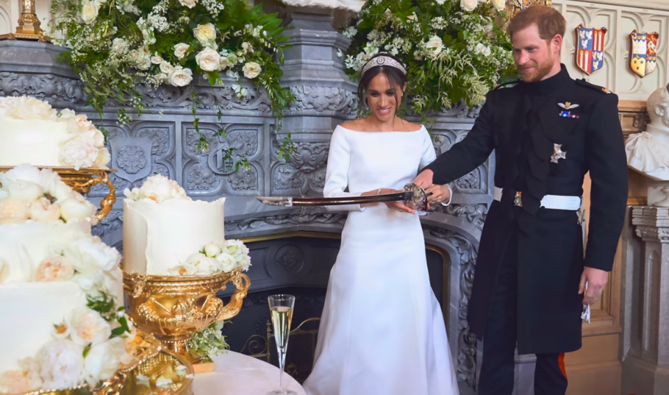 Harry and Meghan cut the cake at their drinks reception (Netflix)