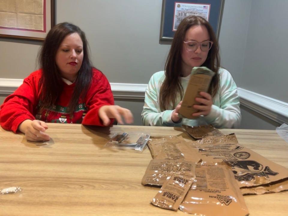 From left to right, military reporter Rachael Riley and food reporter Taylor Shook taste-test Army MREs.