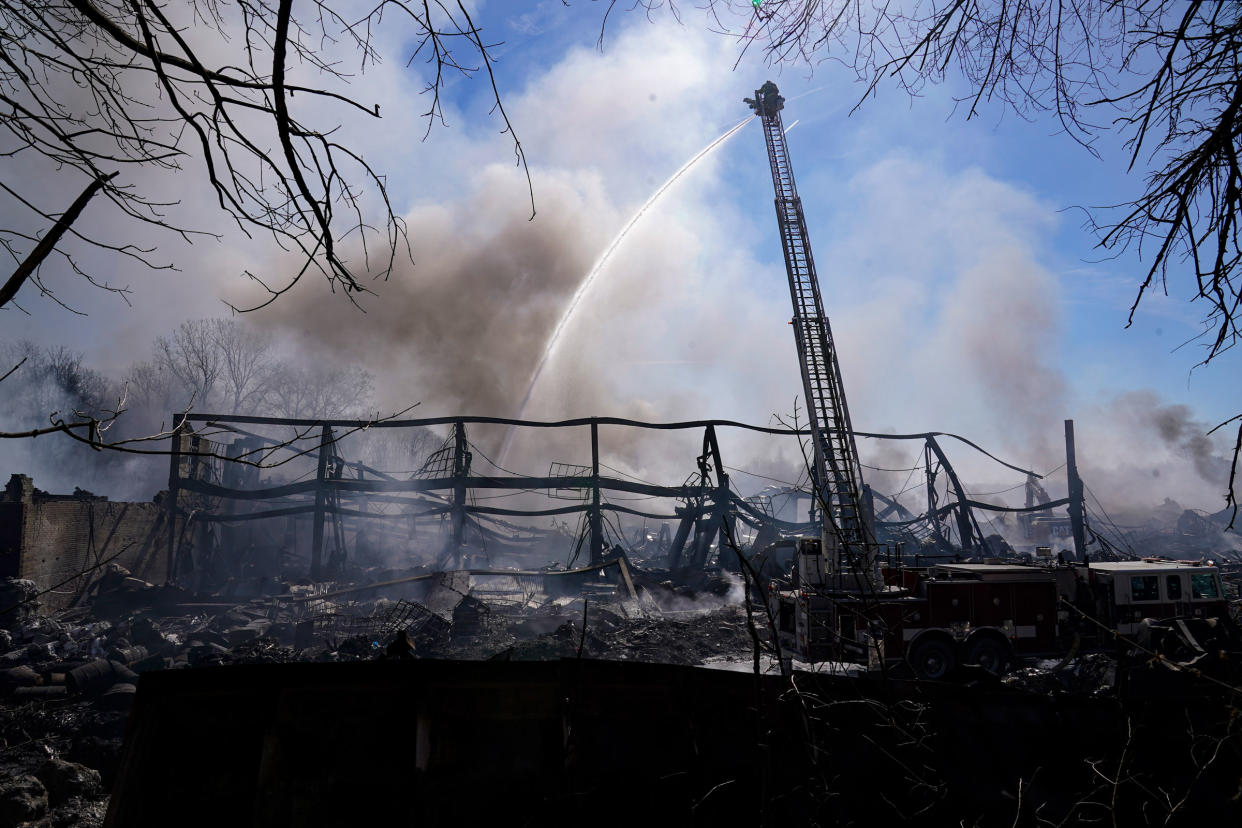 Firefighters pour water on an industrial fire in Richmond, Ind., on April 13, 2023.