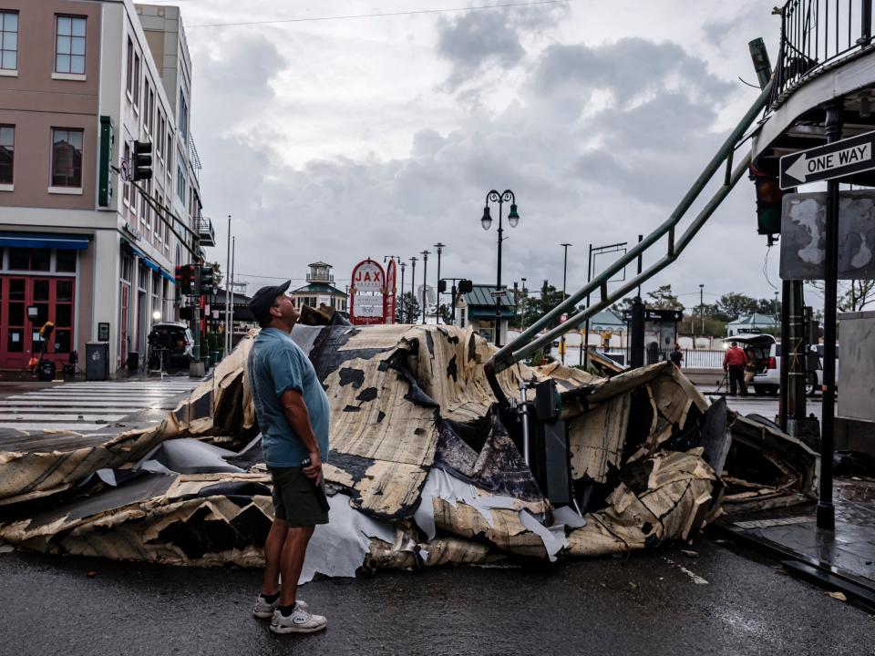 A man looks up next to a chunk of roof that ripped off a building the French Quarter due to Hurricane Ida in New Orleans, Louisiana (EPA)