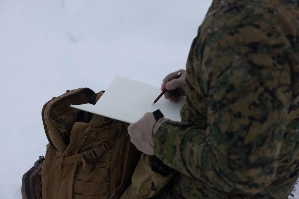 a combat artist with the Marine Corps Combat Art Program illustrates Marines during cold weather training.