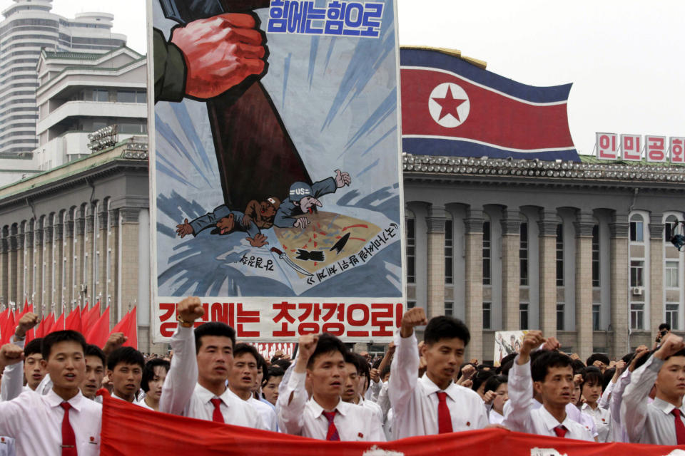 FILE - In this June 25, 2013 file photo, North Koreans chant slogans on Kim Il Sung Square in Pyongyang, North Korea as they hold an anti-U.S. demonstration during the 63rd anniversary of the outbreak of the three-year Korean War, from 1950 to 1953. The poster reads "Meet Force with Force," top, "National Missile Defense System. A Strong Stand," center, and "Meet Hardliners with Harder Attitudes," bottom. North Korea’s propaganda machine is churning out near-daily diatribes against the United States and South Korea for a series of soon-to-start military maneuvers, warning nuclear war could be imminent and saying it will take dramatic action of its own if further provoked. (AP Photo/Jon Chol Jin, File)