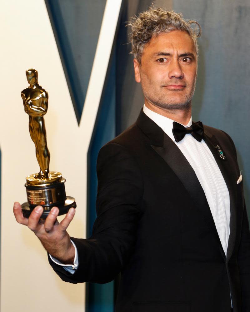 Taika Waititi with the best adapted screenplay Oscar statuette he won earlier this month.