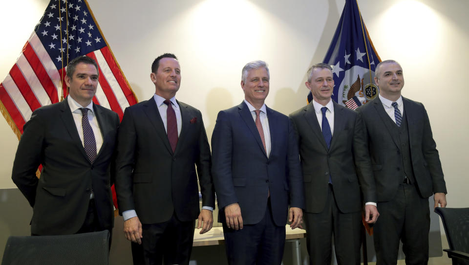 From left, Milun Trivunac, State Secretary of the Ministry of Economy of the Republic of Serbia, Richard Grenell, left, United States Ambassador to Germany, Robert C. O'Brien, United States National Security Advisor, Michael Knitter, Managing Director of Eurowings, and Eset Berisha, Director General, Civil Aviation Authority of Kosovo, pose for the media during a press conference in Berlin, Germany, Monday, Jan. 20, 2020 after the signing of an agreement between Kosovo and Serbia, establishing air service between the two capitals. (AP Photo/Michael Sohn)