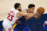 Toronto Raptors guard Fred VanVleet (23) defends against Indiana Pacers guard Malcolm Brogdon (7) during the first half of an NBA basketball game in Indianapolis, Sunday, Jan. 24, 2021. (AP Photo/Michael Conroy)