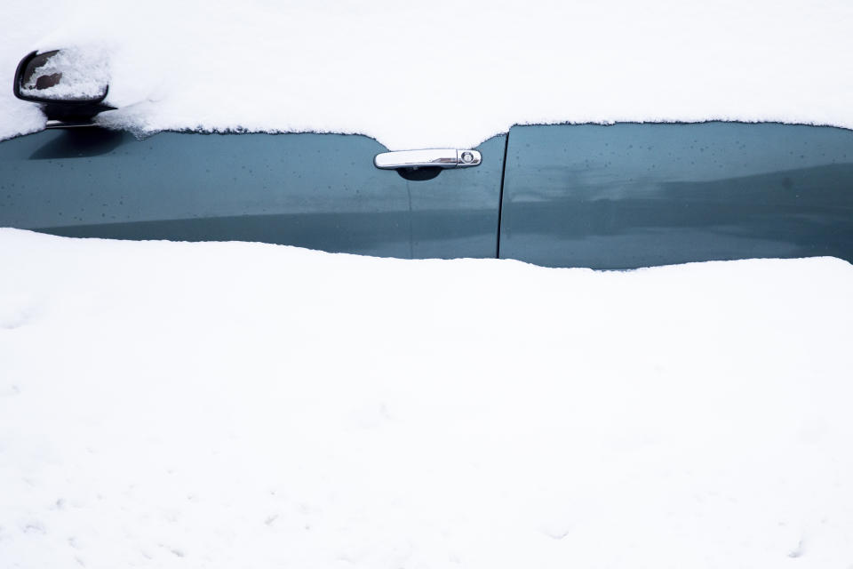 A car sits in a snowdrift Friday, Nov. 18, 2022, in Buffalo, N.Y. A dangerous lake-effect snowstorm paralyzed parts of western and northern New York, with nearly 2 feet of snow already on the ground in some places and possibly much more on the way. (AP Photo/Joshua Bessex)