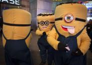 Mascots dressed up as the Minion characters from the movie 'Despicable Me' wait for people to take a photo with them for tips on Thanksgiving in New York November 28, 2013. REUTERS/Carlo Allegri