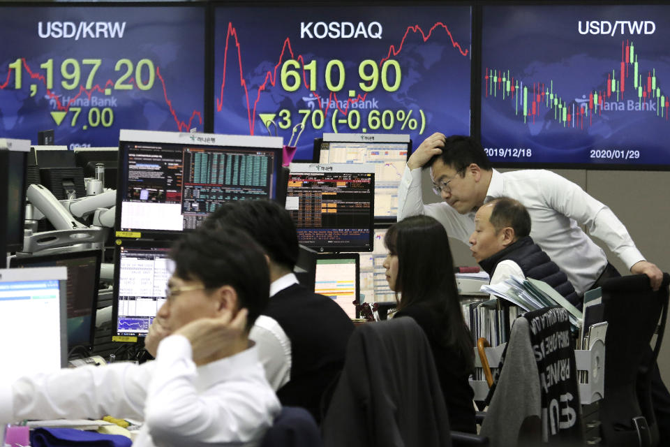 Currency traders watch monitors at the foreign exchange dealing room of the KEB Hana Bank headquarters in Seoul, South Korea, Tuesday, March 10, 2020. Shares edged slightly lower in Tokyo and Seoul after bouncing in and out of negative territory. (AP Photo/Ahn Young-joon)