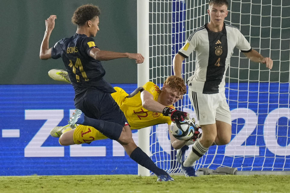 Germany's goalkeeper Konstantin Heide makes a safe against France's Tidiam Gomis, left, during their U-17 World Cup final soccer match at Manahan Stadium in Surakarta, Indonesia, Saturday, Dec. 2, 2023. (AP Photo/Achmad Ibrahim)