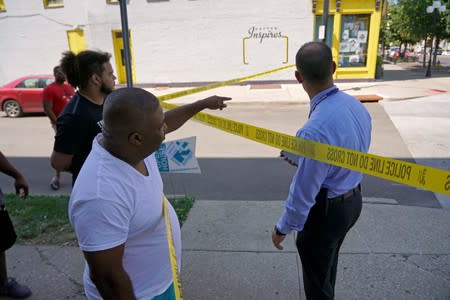 Seth Jacobs, a witness to last night mass shooting, speaks with investigators in Dayton
