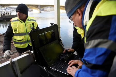 Volunteers of Israeli rescue and recovery organisation ZAKA survey images transmitted by an underwater sonar during a search for the remains of Holocaust victims murdered on the banks of the Danube river in 1944 in Budapest, Hungary January 15, 2019. REUTERS/Tamas Kaszas