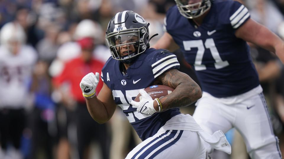 BYU's Tyler Allgeier bursts into the clear on a touchdown run.