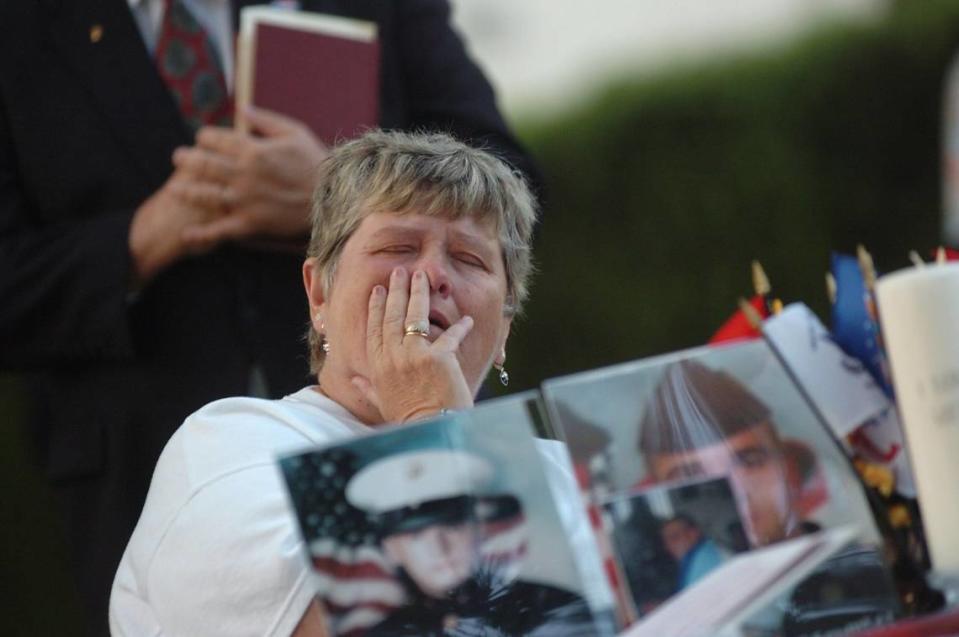 Sheila Cobb fights back tears during a candle light service on April 8, 2006, at Manasota Memorial Park in memory of her son Pfc. Christopher Cobb, and Spc. Justin Schmidt, Lance Cpl. Scott Dougherty and Sgt. Paul Mardis, all of whom were Manatee County men killed during military operations in 2004.