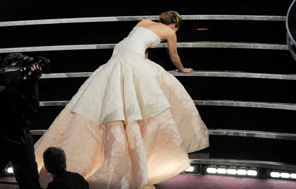 Jennifer Lawrence trips as she heads to the stage to accept best actress for "Silver Linings Playbook" at the Oscars in 2013.