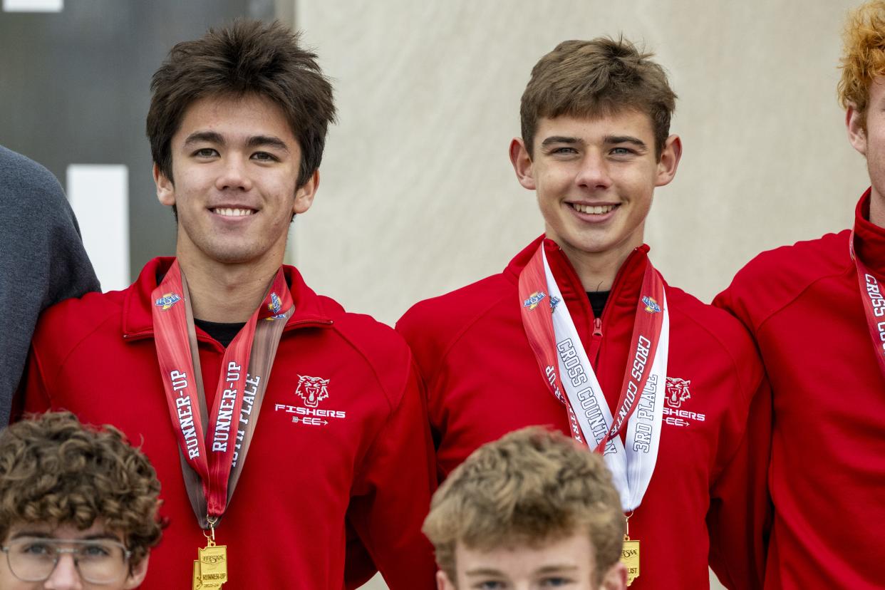 Fishers High School senior Matthew Kim, left, and junior Sam Quagliaroli pose for photos after the 78th annual IHSAA Boys Cross Country State Championship, Saturday, Oct. 28, 2023, at LaVern Gibson Championship Cross County Course.