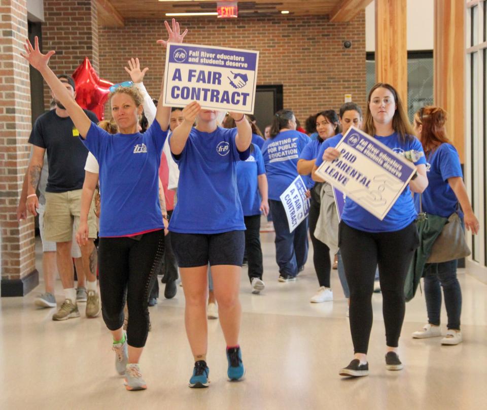 Members of the Fall River Educators Association hold signs demanding a fair contract at a School Committee meeting held at B.M.C. Durfee High School on Monday, June 10, 2024.