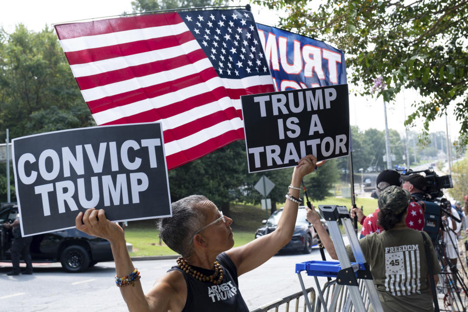 Laurie Arbeiter came from New York City to be at the Fulton County Jail in Atlanta on Thursday, Aug. 24, 2023. Dozens of Trump supporters gathered outside the jail where former President Donald Trump is expected to turn himself in on charges related to his efforts to remain in power after his 2020 election loss. (AP Photo/Ben Gray)