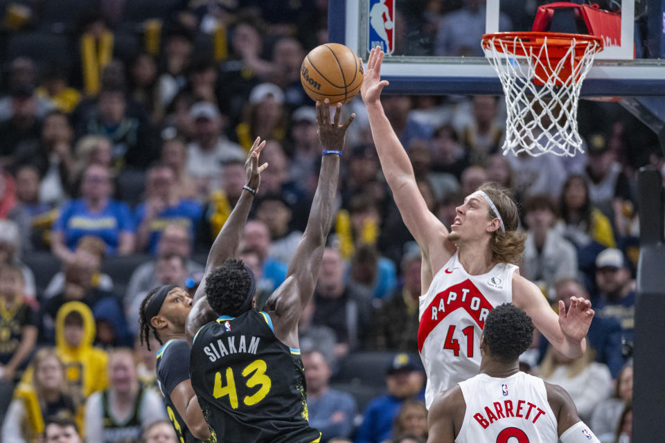 Toronto Raptors forward Kelly Olynyk (41) blocks a shot by Indiana Pacers forward Pascal Siakam (43) during the second half of an NBA basketball game in Indianapolis, Monday, Feb. 26, 2024. (AP Photo/Doug McSchooler)