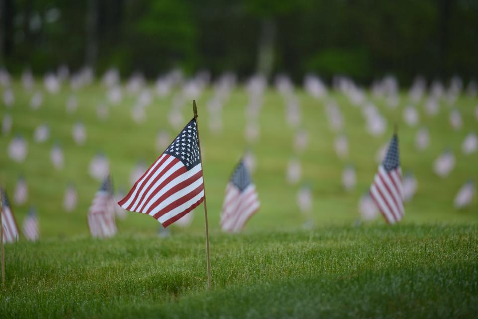 Northeast winds kept the flags fluttering as a large crowd turned out last year at the Massachusetts National Cemetery in Bourne for Operation Flags for Vets, where nearly 80,000 new flags were placed on the graves for Memorial Day.