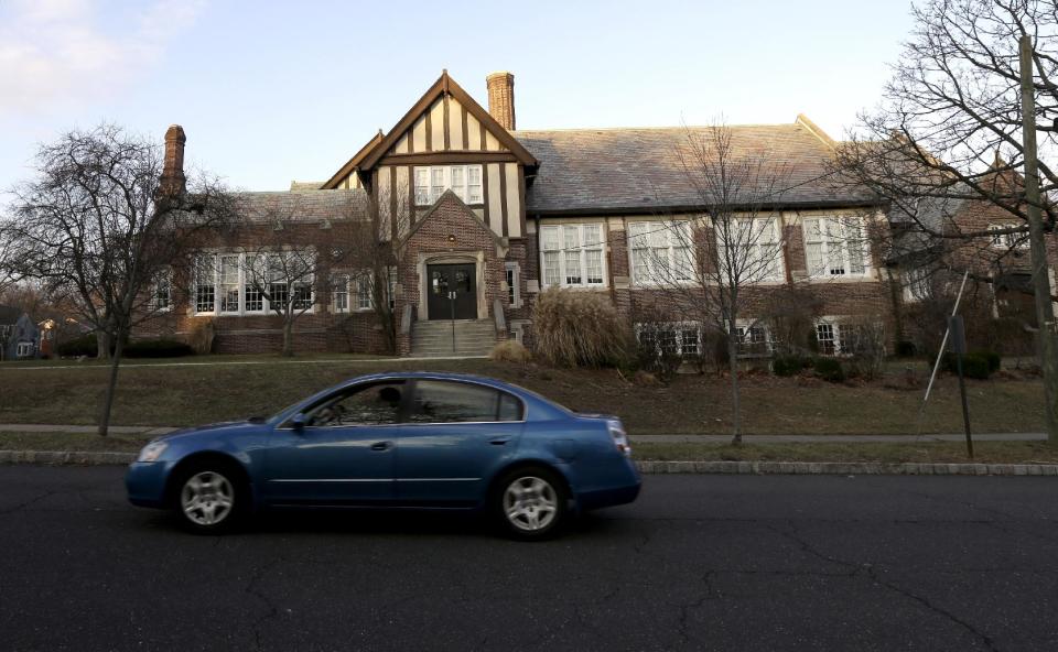 In this Dec. 27, 2013, photo, a car drives past Forest Avenue Elementary School in Glen Ridge, N.J. A presidential commission appointed by President Barack Obama is grappling with concerns that some schools no longer want to serve as polling places amid security concerns since the shooting in Newtown, Conn. Among those schools that have closed to balloting is Linden Avenue Elementary School. (AP Photo/Julio Cortez)