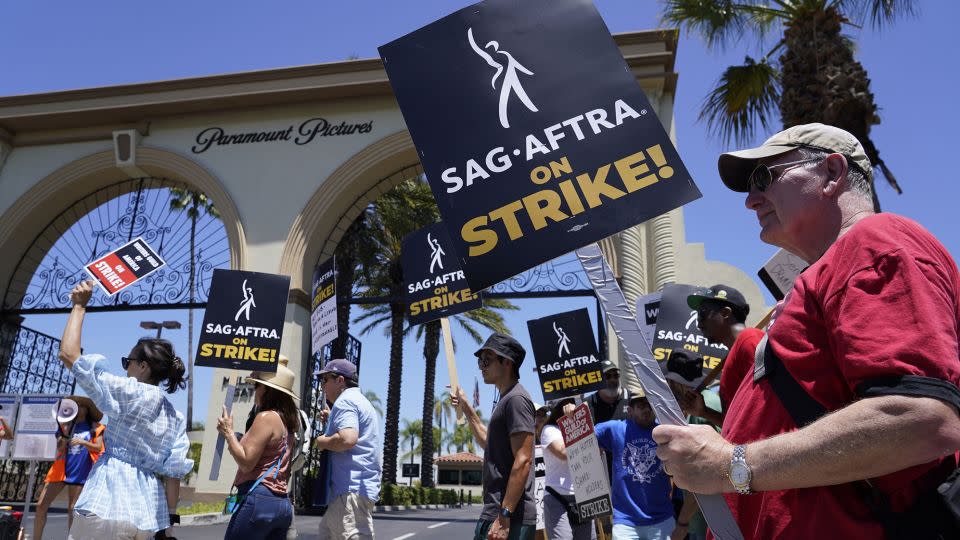 Striking writers and actors take part in a rally outside Paramount studios in Los Angeles on Friday, July 14, 2023. This marks the first day actors formally joined the picket lines, more than two months after screenwriters began striking in their bid to get better pay and working conditions. - Chris Pizzello/AP