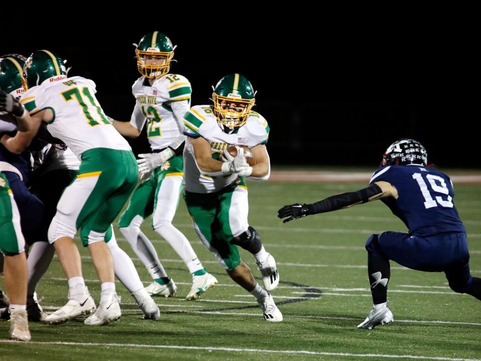 Mason Hackett runs with the ball during Newark Catholic's 21-7 loss to Warren John F. Kennedy in a Division VII state semifinal Nov. 26 in Orrville.