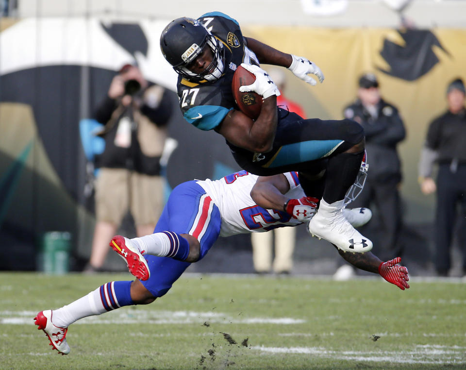 FILE - In this Jan. 7, 2018, file photo, Jacksonville Jaguars running back Leonard Fournette (27) makes a reception over Buffalo Bills defensive back Leonard Johnson in the second half of an NFL wild-card playoff football game in Jacksonville, Fla. Fournette missed seven full games and half of two others with hamstring and foot injuries. He was suspended for another after coming off the bench and punching Buffalo defensive lineman Shaq Lawson. What Fournette does will go a long way toward determining whether the Jaguars remain at the bottom of the AFC South or return to being conference contenders. (AP Photo/Stephen B. Morton)