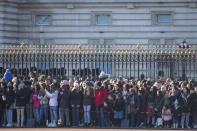 Crowds watch the changing of the guard ceremony outside Buckingham Palace, following a statement by Britain's Queen Elizabeth II and Buckingham Palace, in London, Sunday, Jan, 19, 2020. Buckingham Palace says Prince Harry and his wife, Meghan, will no longer use the titles "royal highness" or receive public funds for their work under a deal that allows them to step aside as senior royals. (Dominic Lipinski/PA via AP)