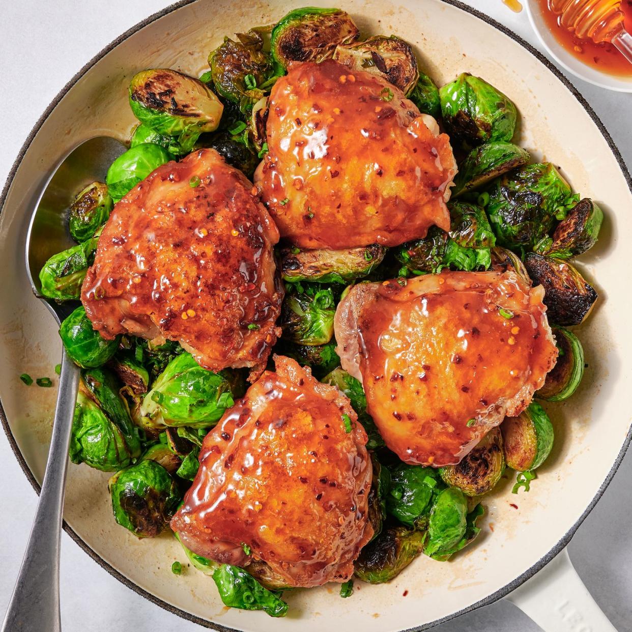 hot honey chicken and brussels sprouts in a pan